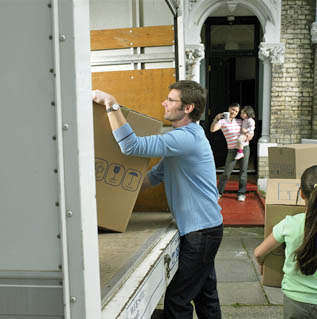 Mover loading a box onto a van